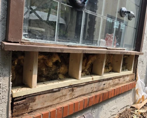 the process of repairing of damaged arch window bottom
